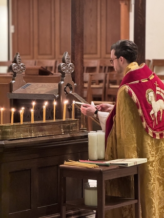 The Rev’d Canon Greg Baker ’20 MDiv lighting candles in Christ Church Cathedral, Indianapolis.