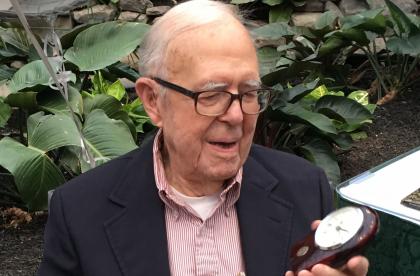 The Rev. Aaron Manderbach '37 opens a gift of a desk clock on the occasion of his 105th birthday.